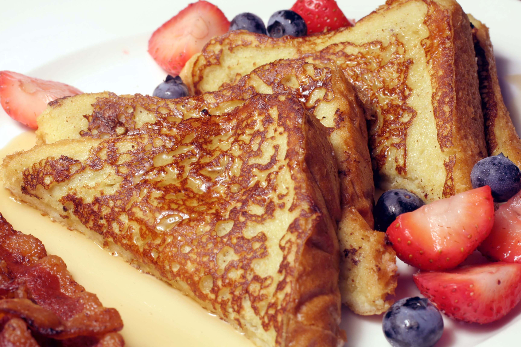 French toast and syrup with a side of bacon and fruit United Zion Retirement Center - Sunday Brunch