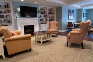 A cozy living room at UZRC that promotes socialization, one of the many benefits of implementing the neighborhood model of healthcare. 