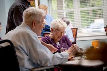 Two seniors enjoying community life activities while living at a senior independent living cottage at UZRC in Lititz, PA.