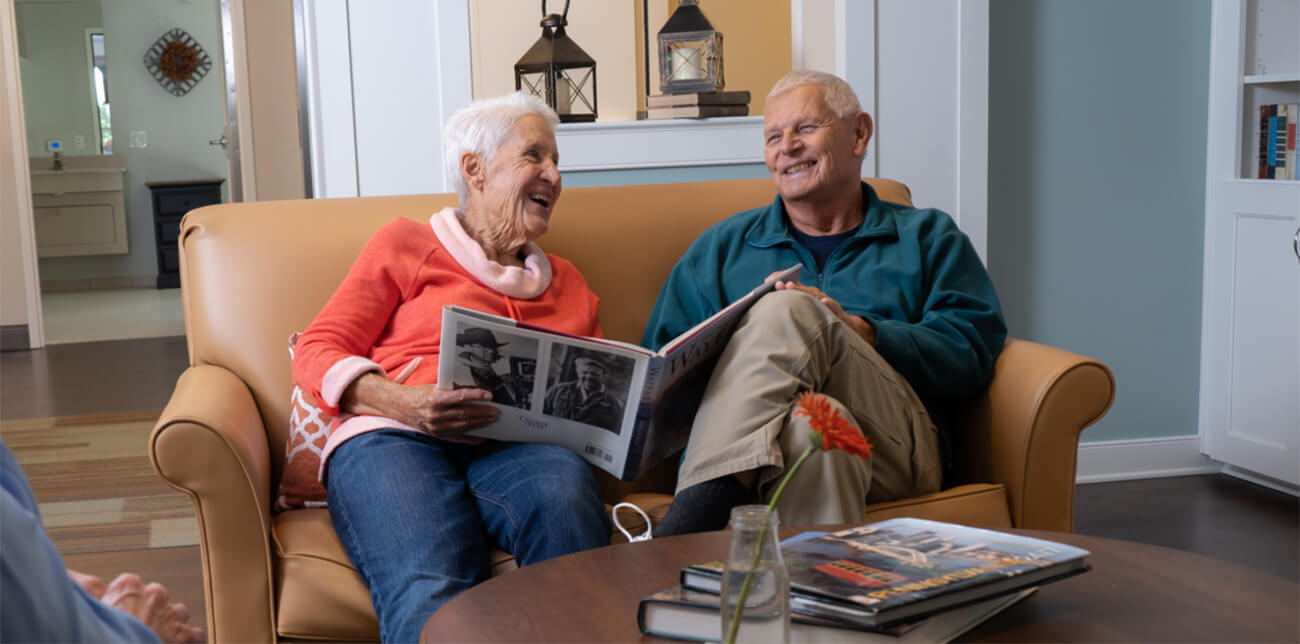 Residents smiling while receiving memory care services from UZRC staff trained with the Montessori Method.